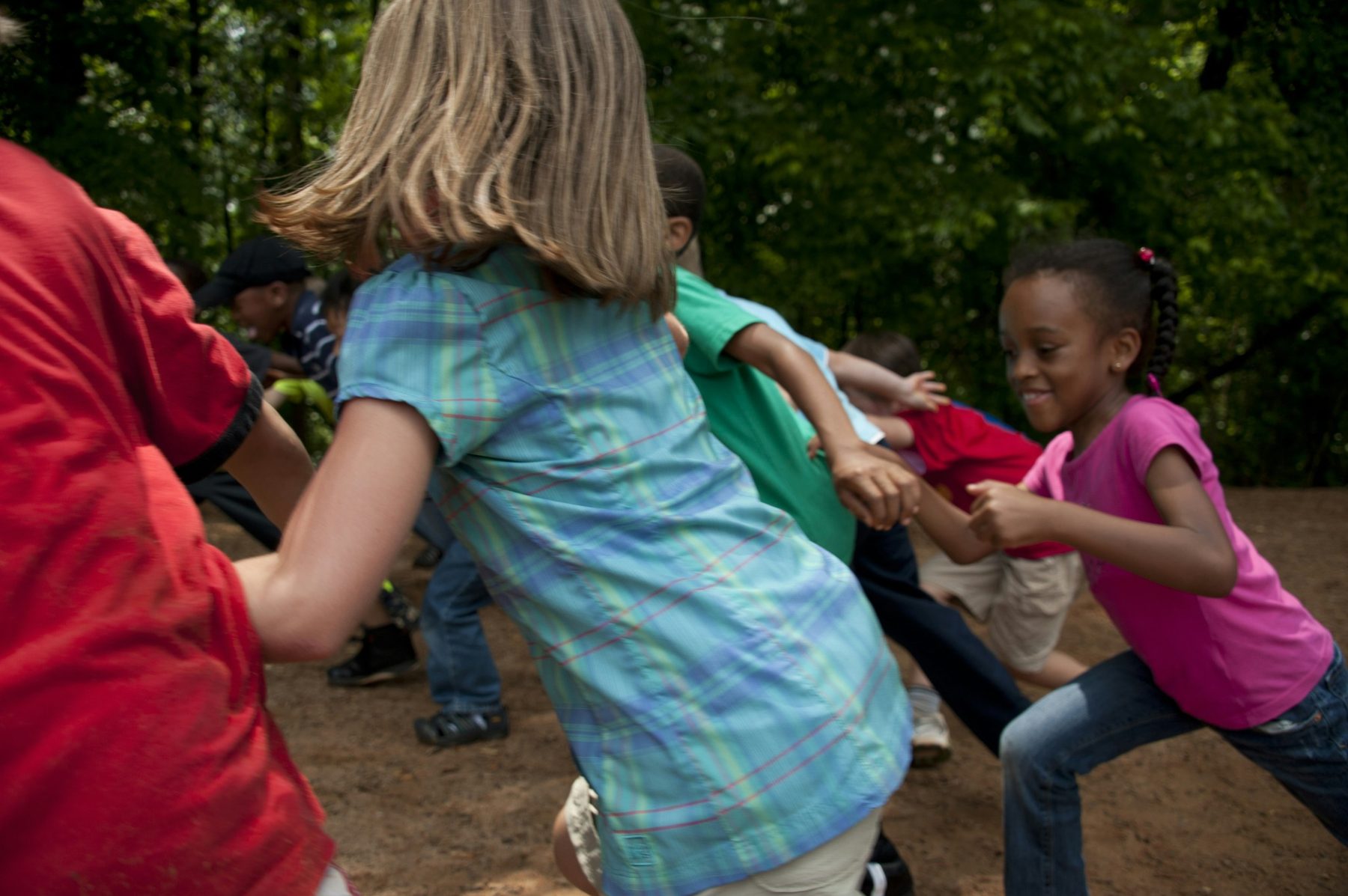 Children moving and playing together outdoors